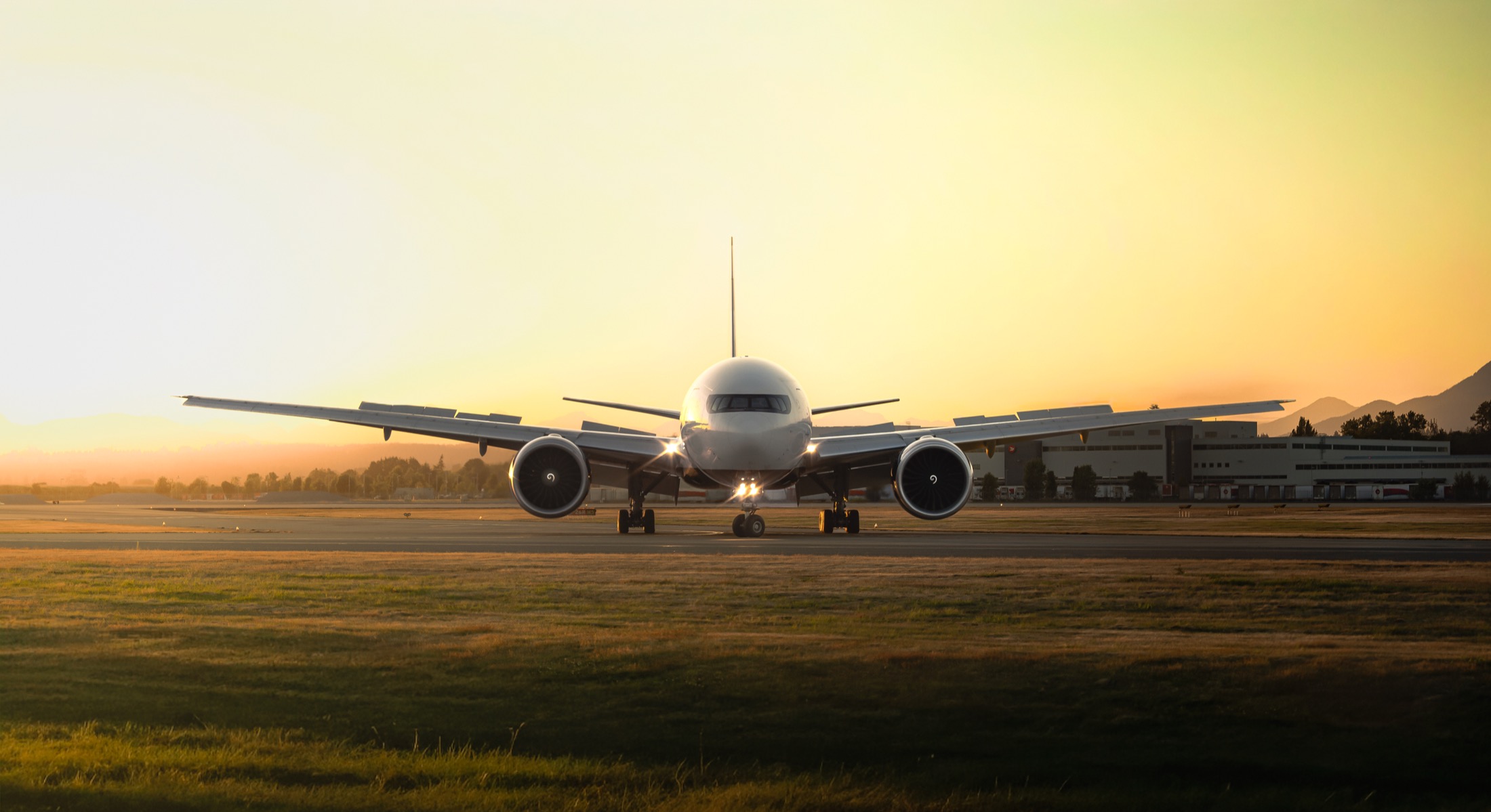 Aircraft facing the camera on a runway at sunset