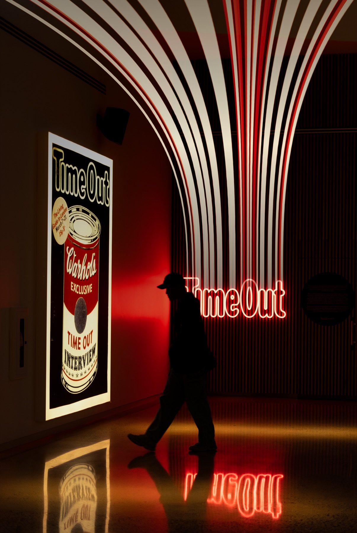 Editorial neon installation with a silhouetted person